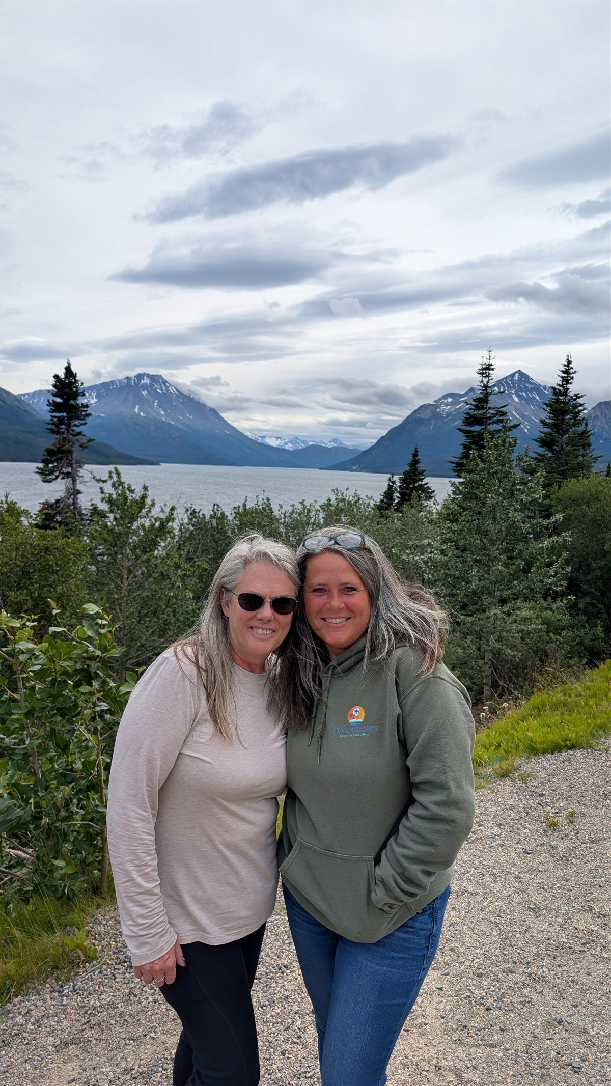 Katie Mills and Jacque' McKinley of Fins Agency overlooking a mountain lake in Alaska