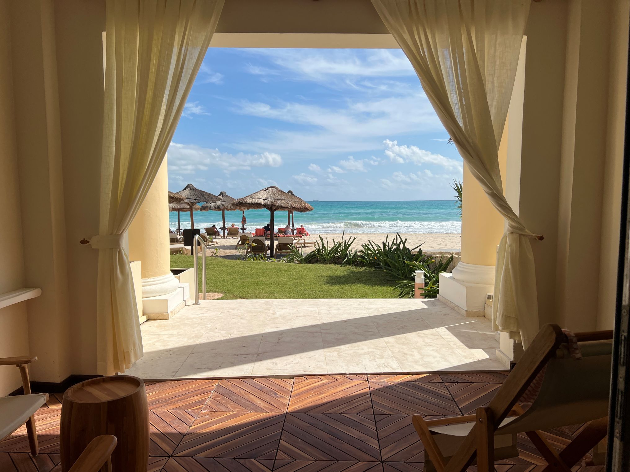 All-inclusive resort room with a patio and ocean view.