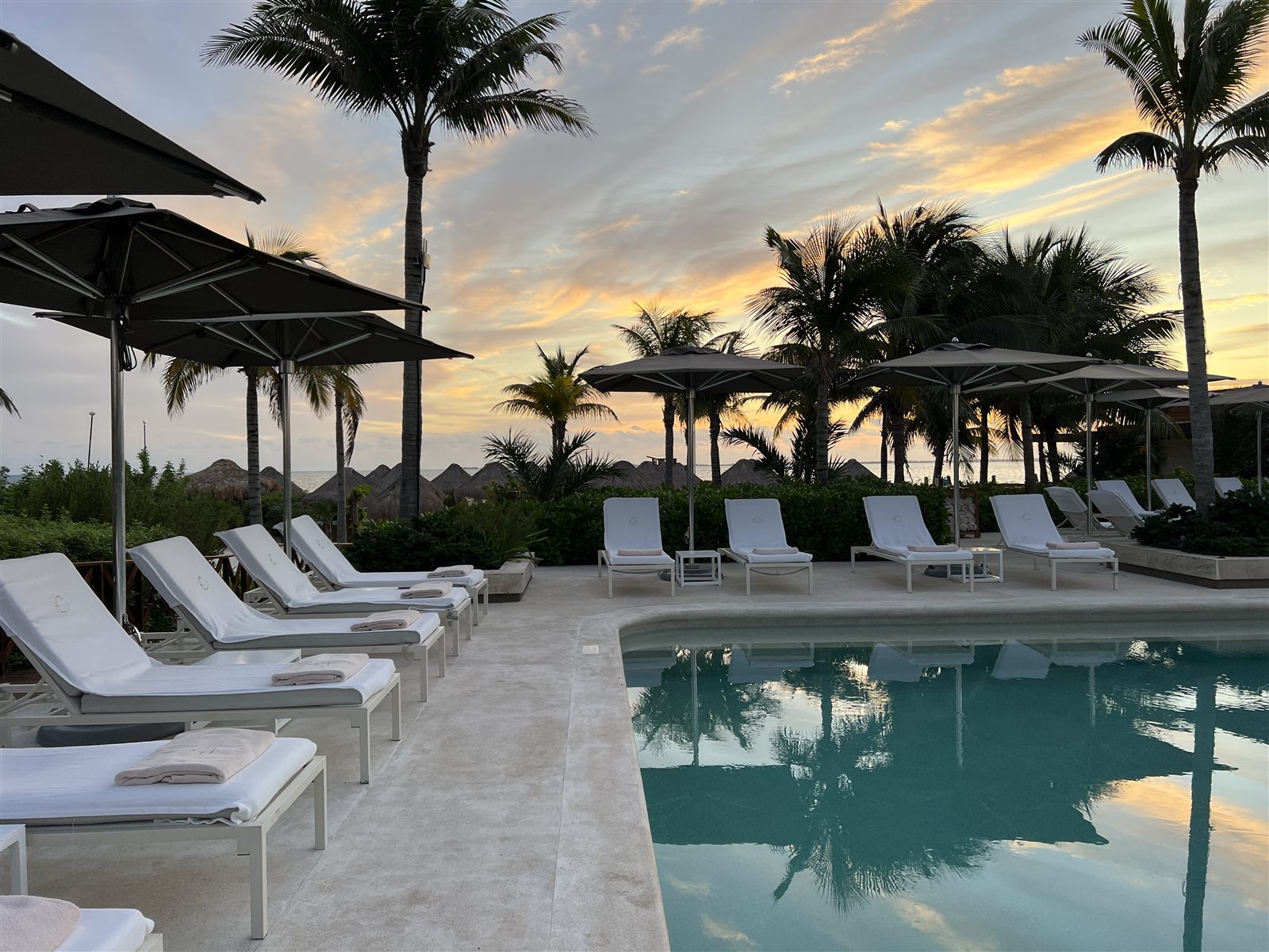 Sunset over the Inspira beachfront pool at Atelier Playa Mujeres